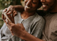 Happy black couple using a smartphone