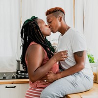 Happy lesbian couple kissing in the kitchen