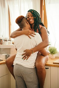 Happy gay couple hugging in the kitchen