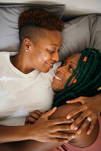 Happy lesbian lovers in bed