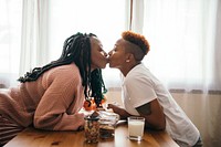 Happy lesbian couple kissing in the kitchen