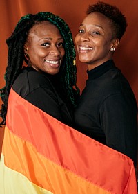 Happy lesbian couple with a colorful flag