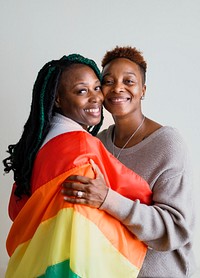 Happy lesbian couple with a colorful flag