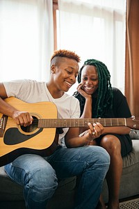 Happy lesbian couple enjoying playing music together