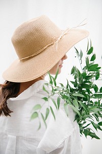 Rearview of a brown hair woman in a woven hat