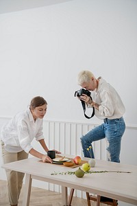 Blogger photographing the plate decor on the dining table