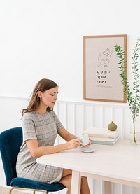 Woman sitting on a chair holding coffee cup