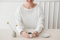 Smiling tattooed woman having a coffee