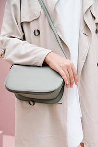 Woman in a beige coat with her shoulder bag