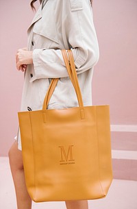 Woman carrying a brown handbag mockup