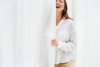 Smiling woman by the white curtain