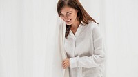 Smiling woman by the white curtain