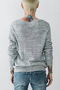 Woman standing facing the wall with a tattooed neck