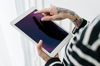 Tattooed woman using a tablet