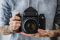 Photographer shooting with a black analog camera