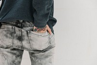 Tattooed woman with her hand in her jeans pocket