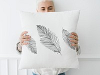 Woman  holding a leafy white pillow mockup