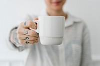 Smiling tattooed woman having a cup coffee mockup