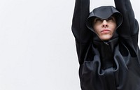 Woman in a cool black hoodie put her hands up in the air