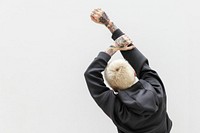Woman in a cool black hoodie put her hands up in the air