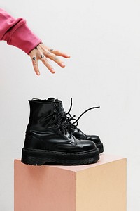Hand reaching out for combat boots