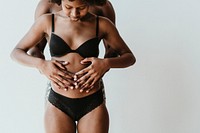 Black couple touching the baby bump