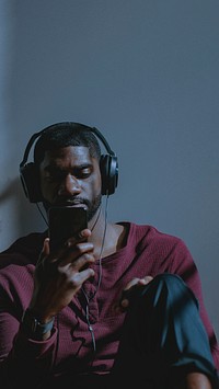 Black man watching a video clip from his phone
