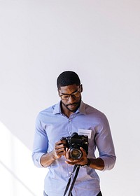 Black photographer using a retro film camera