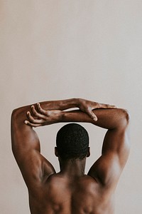 Rear view of black man holding his arms