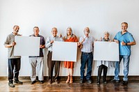 Elderly people holding blank posters