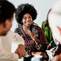 Cheerful woman speaking on a microphone in a workshop