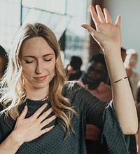 White woman raising her hand