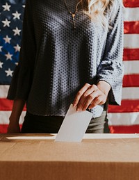 American casting her vote to a ballot box