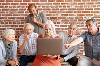 Group of elderly people using a laptop