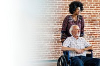 Black woman pushing her patient's wheelchair