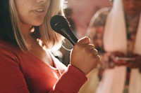 Closeup of a woman speaking on a microphone