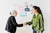 Businesswomen shaking hands making a business deal