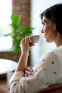 Woman sipping coffee at a cafe