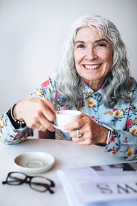 Senior woman sipping coffee in a cafe