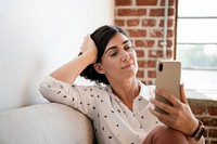 Woman on the couch using a smartphone