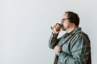 Man drinking a hot coffee while listening to music