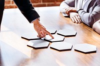 Business people with connected hexagon cut out papers