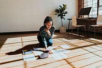 Businesswoman planning a marketing strategy on a wooden floor