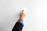 Hand pointing to a white wall