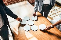 Business people with connected hexagon cut out papers