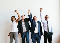 Diverse business team raising hands up in the air