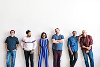 Group of people standing in a by a white wall