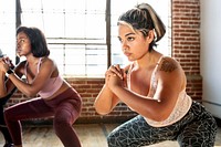 Women doing squats in fitness class