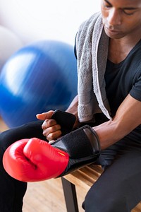 Active man wearing boxing gloves