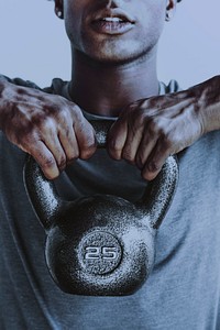 Muscular man weightlifting with a kettlebell